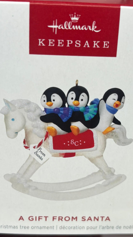 Hallmark Keepsake ornament packaging with penguins and a horse on a white background