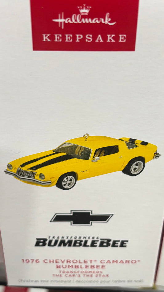 Hallmark Keepsake ornament packaging with a yellow car design on a shelf.